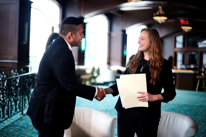 A Turning Stone team member is shaking a job candidate’s hand after his successful interview. 